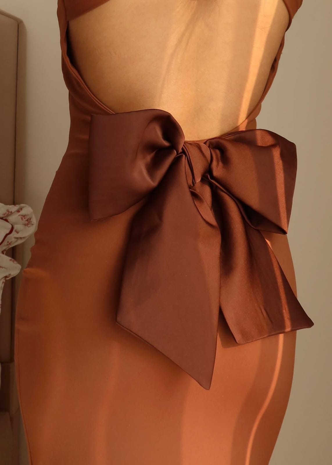 Close-up of the oversized bow on the back of the Amora Bow Bodycon